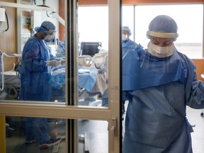 An ICU team helping to intubate a patient suffering from COVID-19 at Humber River Hospital in Toronto. (Photo by Cole Burston / AFP)