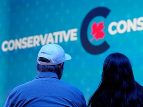 Supporters watch results at Conservative Leader Erin O'Toole's election night headquarters in Oshawa, Ont., during the federal election on Sept. 20, 2021.