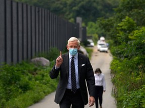 Dominic Barton, Canada Ambassador to China, wearing a face mask gestures after meeting with Canadian Michael Spavor at a detention center in Dandong, China, Wednesday, Aug. 11, 2021.