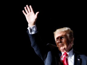 Former U.S. Presidemt Donald Trump waves  during a rally in Des Moines, Iowa, U.S., October 9, 2021. REUTERS/Rachel Mummey