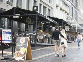 People walk past an outdoor restaurant in downtown Montreal on June 5, 2021. The effects of Quebec's Bill 96 on Montreal’s commercial life will be stultifying, predicts Barbara Kay.