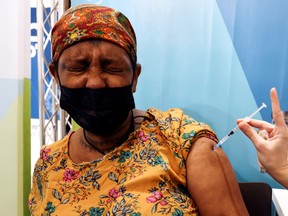 An Israeli woman receives her third dose of the coronavirus disease (COVID-19) vaccine, in Jerusalem, October 3, 2021.