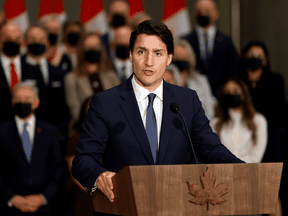 Prime Minister Justin Trudeau speaks in front of members of his new cabinet on October 26, 2021.