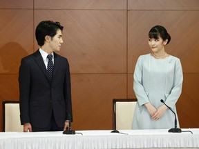 Japan's former princess Mako (R), the elder daughter of Prince Akishino and Princess Kiko, and her husband Kei Komuro (L), who she originally met while at university, pose during a press conference to announce they have married, at the Grand Arc Hotel in Tokyo on October 26, 2021.