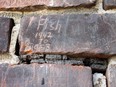 A survivor of the former Mohawk Institute Residential School has carved his name and dates of attendance into one of its  bricks.