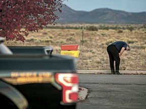 A distraught Alec Baldwin lingers in the parking lot outside the Santa Fe County Sheriff's Office in Santa Fe, N.M., after he was questioned about a shooting on the set of the film "Rust" on the outskirts of Santa Fe, Thursday, Oct. 21, 2021. Baldwin fired a prop gun on the set, killing cinematographer Halyna Hutchins and wounding director Joel Souza.