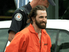 Greenpeace activist Steven Guilbeault is led away by police after scaling Toronto’s CN Tower on July 16, 2001.