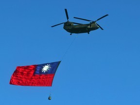 A Taiwan flag is carried across the sky during a rehearsal on October 5, 2021, for national day in Taipei, Taiwan.