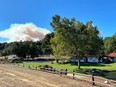 A smoke column from the Alisal Fire builds in the distance behind former U.S. President Ronald Reagan's Rancho del Cielo on Wednesday afternoon. The area between the ranch and the fire had good defensible space, the fire department said, and engines were providing structure protection.