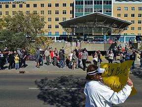 People protest outside the Royal Alexandra Hospital in Edmonton on Sept. 13.