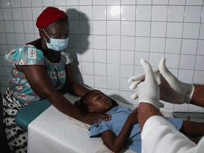 A health worker prepares to take care of a child with malaria at a hospital in Abidjan, Ivory Coast October 7, 2021.