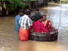 A bride and groom float to a temple in a cooking vessel on a flooded road for their wedding ceremony in this screengrab taken from video, in Alappuzha, Kerala, India, October 18, 2021.