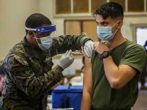 Military medical personnel at Camp Lejeune, N.C., administer coronavirus vaccines in January.