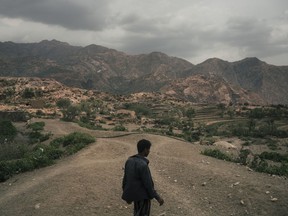 Mohammed Fulait Ahmed walks among the hills of his village, Moulis, in Yemen's Maghrabah district.