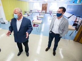 Ontario Premier Doug Ford, left, and Education Minister Stephen Lecce tour a school on Sept. 1, 2020.