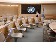A man walks past a United Nations logo next to seats blocked by warning tape, ahead of the opening of a session of the UN Human Rights Council, in Geneva, on Sept. 13.