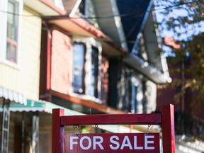 A for sale sign is displayed in front of a house in the Riverdale area of Toronto on Wednesday, September 29, 2021. THE CANADIAN PRESS/Evan Buhler ORG XMIT: EEB118
