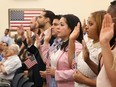 People  participate in a ceremony to become American citizens in Miami in 2018.