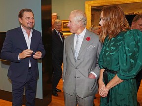 Prince Charles, centre, speaks with Leonardo DiCaprio, left, as he views a fashion installation by designer Stella McCartney, at the Kelvingrove Art Gallery and Museum, during the COP26 summit in Glasgow, on Nov. 3.