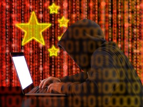 Chinese hacker at work in front of red flag