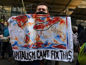 Climate activists from the Extinction Rebellion group demonstrate outside the offices of JP Morgan in Glasgow, during the COP26 UN Climate Change Conference, on November 2, 2021. -