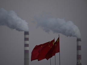 China's national flags flutter in front of a coal-powered power station in Datong, China, on Nov. 3.