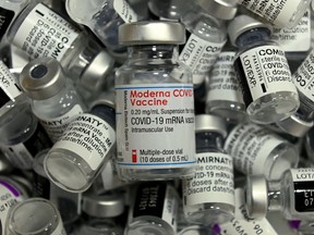 An empty vial of the Moderna COVID-19 vaccine among empty vials of different other vaccines at a vaccination center in Rosenheim, southern Germany.