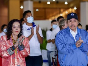 In this file photo taken on November 08, 2021 Handout picture released by the Nicaraguan presidency showing Nicaragua's President Daniel Ortega (R) and his wife and Vice-president Rosario Murillo applauding during the commemoration of the 45th anniversary of the death of one of the founders of the Sandinista National Liberation Front (FSLN) guerrilla, Carlos Fonseca, in Managua.