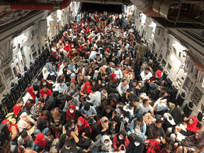 Evacuees termed Canadian Entitled Persons sit in a Royal Canadian Air Force C-177 Globemaster III transport plane for their flight to Canada on Aug. 23.