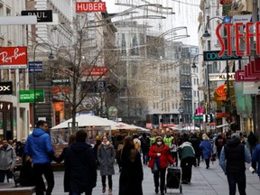 Pedestrians walk along a shopping street after the Austrian government placed roughly two million people who are not fully vaccinated against the coronavirus disease (COVID-19) on lockdown, in Vienna, Austria, November 17, 2021.