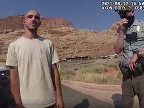 This August 12, 2021, still file image from a police bodycam released by the Moab City Police Department in Utah, shows Brian Laundrie (L) speaking with police as they responded to an altercation between Laundrie and his girlfriend Gabrielle Petito.