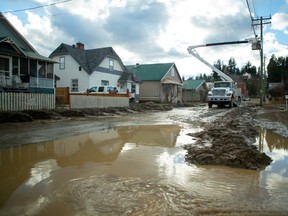A utility crew work a day after severe rain flooded the southern interior town of Princeton, B.C., on Nov. 16.
