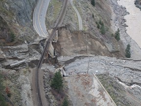 Railway tracks are suspended above the washed out on an underpass of the Trans Canada Highway 1 after devastating rain storms caused flooding and landslides, northeast of Lytton, British Columbia, Canada November 17, 2021. Picture taken November 17, 2021. B.C. Ministry of Transportation and Infrastructure/Handout via REUTERS