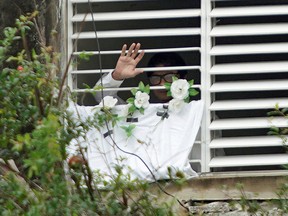 Actor, playwright and leader of the Facebook group 'Archipelago', Yunior Garcia, 39, waves from his home in Havana, Cuba, November 14, 2021.