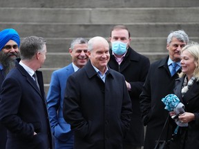 Conservative leader Erin O’Toole, centre, arrives to a Conservative caucus meeting with fellow members of Parliament and staff in Ottawa on Wednesday, Nov. 17, 2021. THE CANADIAN PRESS/Sean Kilpatrick