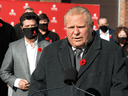 Ontario Premier Doug Ford, with Unifor President Jerry Diaz at left, announces a provincial minimum wage increase to $15 an hour, in Milton on November 2, 2021.