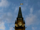 The Canadian flag flies at half-mast atop the Peace Tower on Parliament Hill on Nov. 1, 2021.