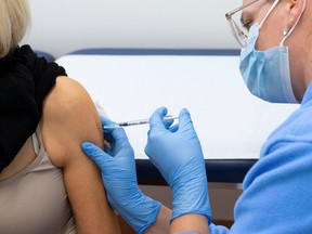 A woman receives a booster shot of Moderna's COVID-19 vaccine in Zurich, on Nov. 17.