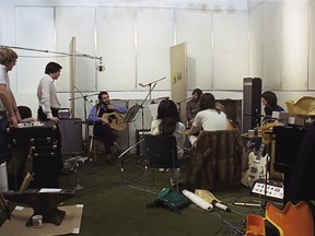 The Beatles, surrounded by equipment and microphones, working on the album Let It Be in 1969.