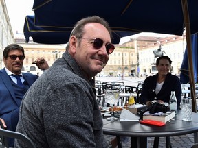 Actor Kevin Spacey sits at a caffe in Piazza San Carlo as he visits the city, where he is expected to return for a cameo appearance in a low budget Italian film, after largely disappearing from public view, in Turin, Italy, June 1, 2021. REUTERS/Massimo Pinca