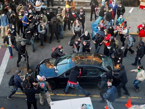 A man tries to drive through the crowd during a June protest in Seattle against racial inequality after the death of George Floyd.