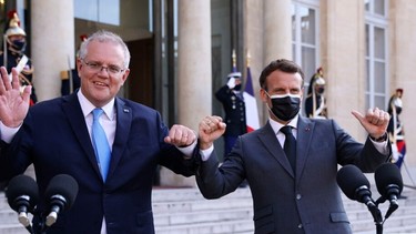 In this file photo taken on June 15, 2021 French President Emmanuel Macron (R) and Australia's Prime Minister Scott Morrison answer the press prior to a working diner at the Elysee Palace in Paris.