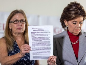 Mamie Mitchell (L), script supervisor on the film "Rust", and attorney Gloria Allred hold a copy of safety recommendations for the use of live ammunition at a press conference after filing a lawsuit on the behalf of Mitchell against actor/producer Alec Baldwin and other producers on the New Mexico set, in Los Angeles, California on November 17, 2021.