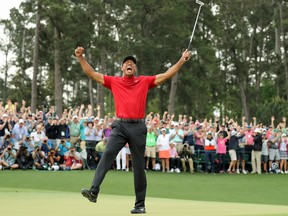 Tiger Woods celebrates winning the 2019 Masters, on the 18th hole.