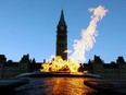 The Centre Block of Canada's Parliament Buildings is seen through the Centennial Flame on Parliament Hill in Ottawa on Jan. 25, 2015.