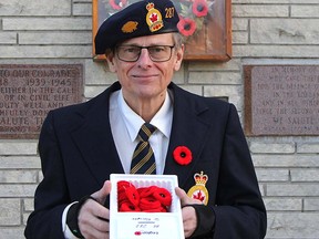 Ross Libby, a member of Royal Canadian Legion Branch 287 in South Porcupine, Ont., offers poppies for purchase in the lead-up to Remembrance Day.