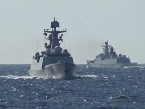 A group of naval vessels from Russia and China conduct a joint maritime military patrol in the waters of the Pacific Ocean.