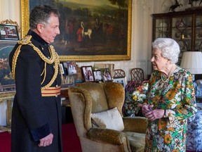 Queen Elizabeth II greets Britain's Chief of the Defence Staff, General Nick Carter, during an audience at Windsor Castle, west of London on November 17, 2021. (Photo by Steve Parsons  / AFP)