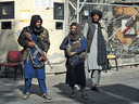 Taliban fighters stand guard at an entrance gate of the Sardar Mohammad Dawood Khan military hospital in Kabul on November 3, 2021, a day after an attack claimed by the Taliban's hardline rivals the Islamic State-Khorasan, in which at least 19 people were killed.