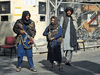 Taliban fighters stand guard at an entrance gate of the Sardar Mohammad Dawood Khan military hospital in Kabul on November 3, 2021, a day after an attack claimed by the Taliban's hardline rivals the Islamic State-Khorasan, in which at least 19 people were killed.